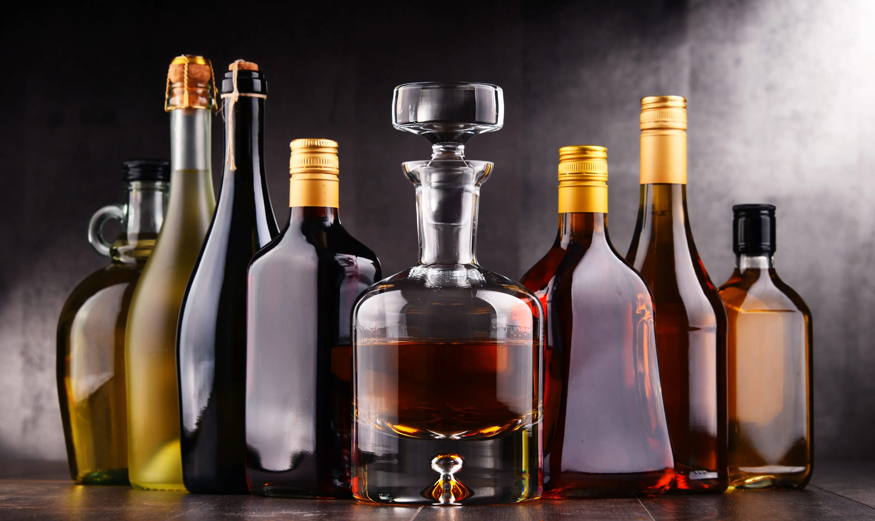 Assortment of liquor bottles and decanter.